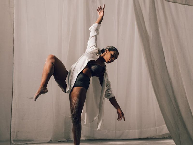Person performing a flowing cardio motion in a studio